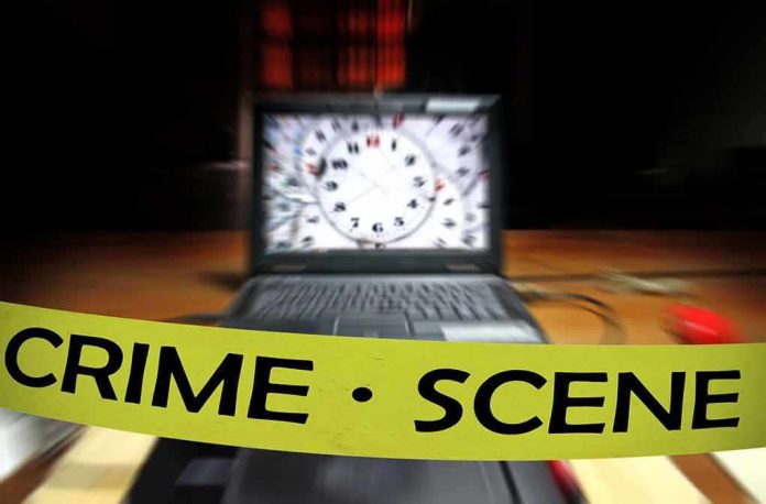 shutterstock_129115370 crime scene tape in front of a blurred laptop