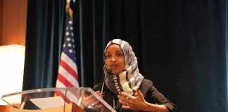 Ilhan Omar’s ‘Un-American’ Bill Targeting ICE Goes Viral Ilhan Omar speaking at a podium with a microphone