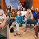 Audience listening to a speaker at a community meeting