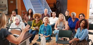 Audience listening to a speaker at a community meeting