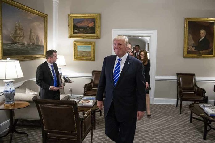 Donald Trump walks through an office with Sean Lawler nearby and Mariano Rajoy following behind