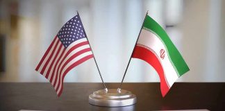 United States and Iran desk flags on a stand