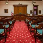 Attorney Makes Stunning Move in Kirk Assassination Hearing! Courtroom with wooden benches facing the judge's bench