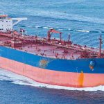 Large cargo ship navigating through the ocean