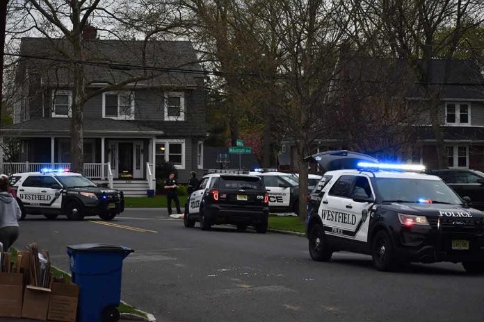 Police SUVs with lights on block a suburban street