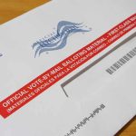 Red-State Shock: Senate Race Deadlocked Mail-in ballot envelope with red label on wooden table