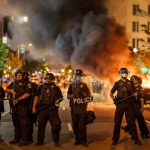 Belfast Erupts: Police Fire Water Cannons! Christian Jones and Teddy Williams among police line at night protest with fire and smoke