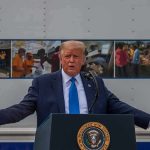 Trump Meets With G7 Leaders After Iran Deal Donald Trump speaks at a podium with arms outstretched