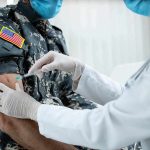 2,544 Troops DEAD – Army Death Audit Launched Healthcare worker giving vaccine to person in military uniform