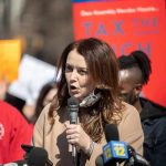 Far-Left Dem Brags About Raising State Taxes Woman speaking into a microphone at a rally