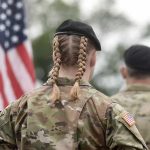 Leaders Panic Over Hegseth’s Military Plans for the Region soldier in camouflage with braided hair and beret