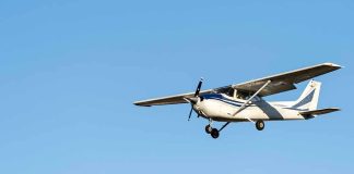 Single-engine airplane flying against clear blue sky