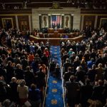 Legislative chamber audience stands and applauds
