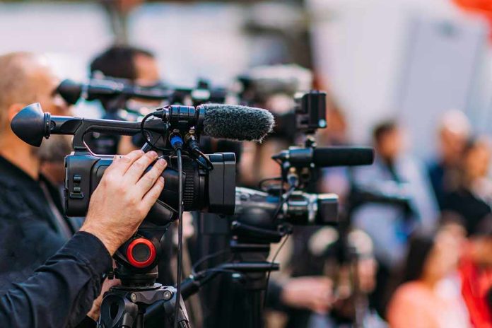 shutterstock_2233193507-2 Video cameras on tripods at a media event