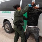 Border Bust NABS 95 Illegal Truckers Border patrol agent detains a person against a van