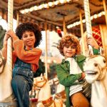 Kids Dangle Mid-Air – Amusement Park BLUNDER! Children riding carousel horses at an amusement park