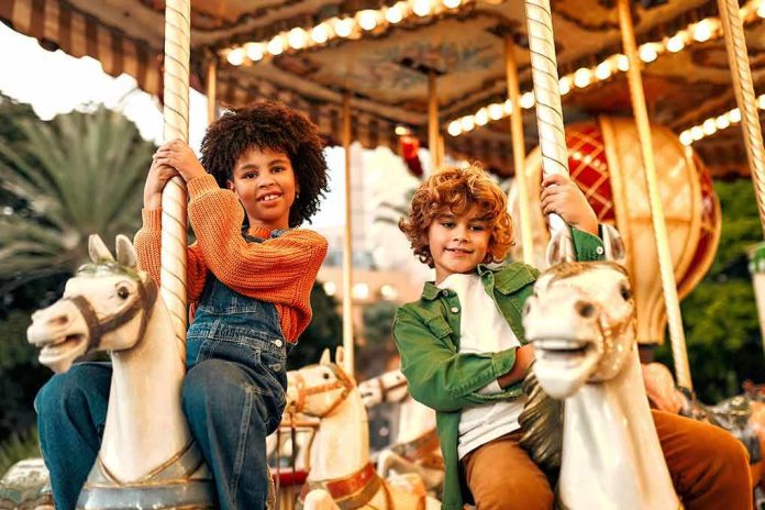 Children riding carousel horses at an amusement park