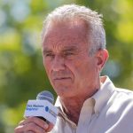 RFK Uses $9,000 an Hour Jet To Attend Conference Man speaking into a microphone outdoors