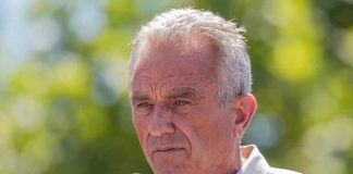 Man speaking into a microphone outdoors