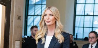 Woman in navy blazer walking indoors