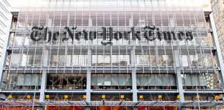 The New York Times building facade with street traffic