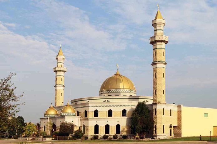 shutterstock_312777998-1 Mosque with golden dome and two tall minarets under a partly cloudy sky