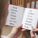 Killer Mother’s Trial Off to CHAOTIC Start Hands holding a notebook with baby name lists near a crib