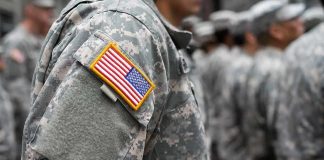 Soldier in camouflage uniform with U.S. flag patch