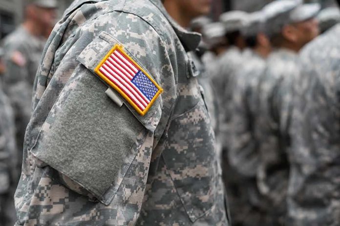 Soldier in camouflage uniform with U.S. flag patch