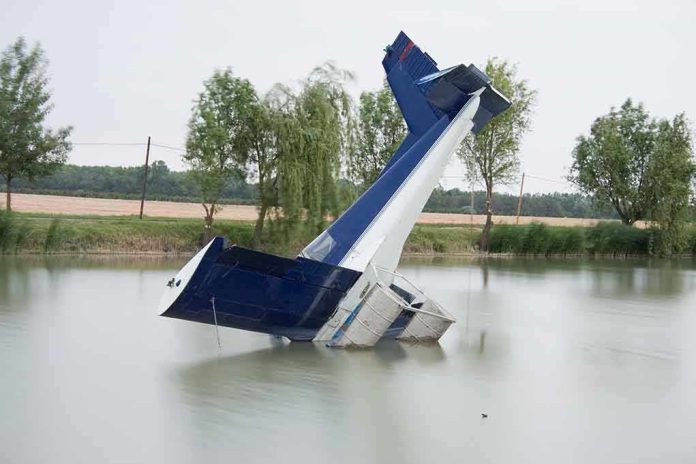 shutterstock_41574586 An abandoned aircraft partially submerged in a calm body of water surrounded by trees