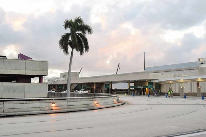 Airport terminal exterior with palm tree at dusk