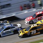 NASCAR Star Jumped By Rivals Pit Crew Stock cars racing side by side on a banked track