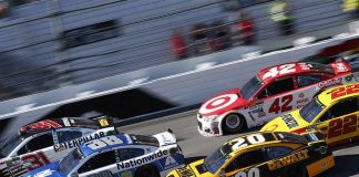 NASCAR Star Jumped By Rivals Pit Crew Stock cars racing side by side on a banked track