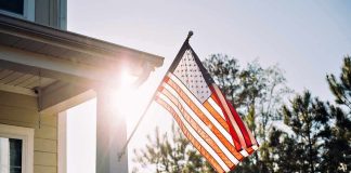 American flag on a house porch at sunset