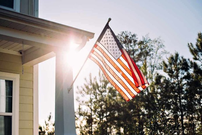 American flag on a house porch at sunset