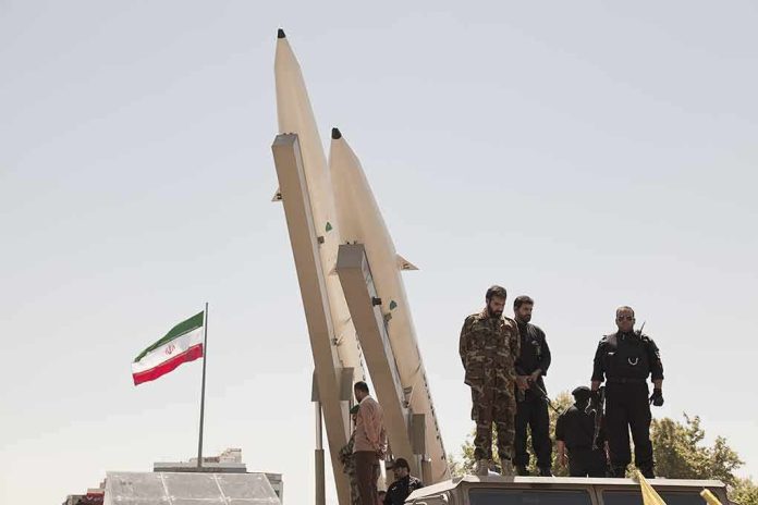 Soldiers stand beside large missiles at an outdoor display