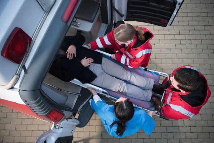 shutterstock_766454218 Paramedics load a patient on a stretcher into an ambulance