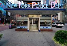 Woman Stalks and Stabs Jewish Man in Daylight NYPD precinct building with signs on a city street