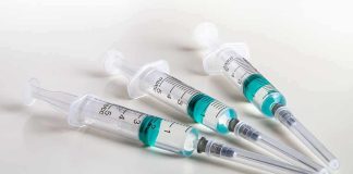 WHO Demand Toddlers Receive STD Vacs! Three syringes filled with blue-green liquid on a white surface