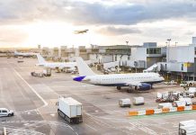 Runway Chaos: Passenger Hijacks Airport Tug Airplanes at airport gates during sunset with ground vehicles and jet bridges
