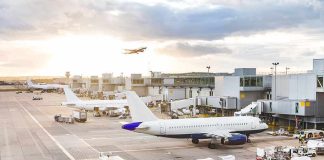 Runway Chaos: Passenger Hijacks Airport Tug Airplanes at airport gates during sunset with ground vehicles and jet bridges