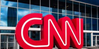 CNN Icon Walks After 43 Years CNN red logo sculpture outside a modern glass building