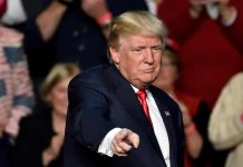 Trump’s Risqué Nicki Moment Infuriates Melania Donald Trump points toward the audience at an event