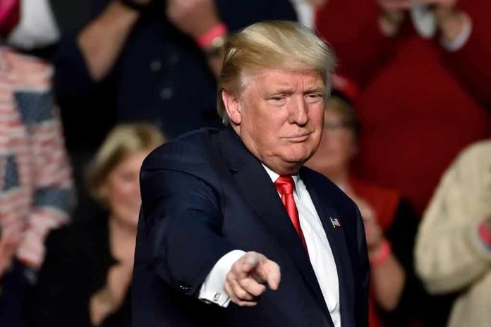 shutterstock_1083789467 Donald Trump points toward the audience at an event