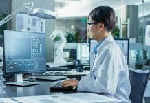 Deadly Bacteria Discovered in LA Office – AIRBORNE Engineer in lab coat working at a computer in a modern lab