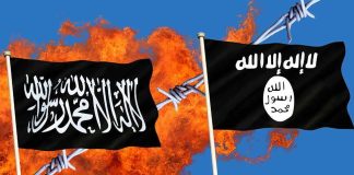 Two black extremist flags in front of flames and barbed wire