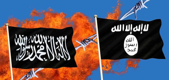 shutterstock_1200426370 Two black extremist flags in front of flames and barbed wire