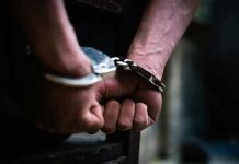 hands in handcuffs behind back