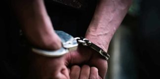 Video Captures Disgraced Rappers Nightclub Brawl hands in handcuffs behind back