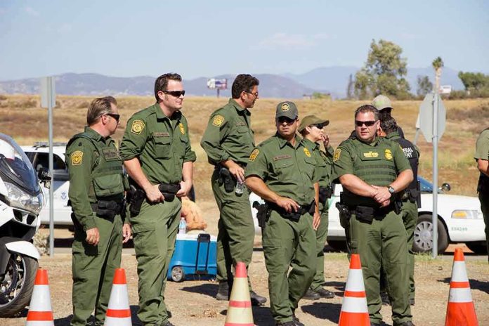 shutterstock_1413417008 Sid Fernandez and Bear Pascoe among uniformed officers standing near traffic cones outdoors